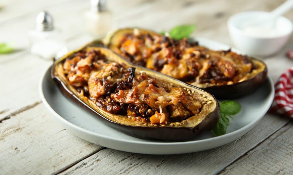 Vegetarian stuffed eggplant shells with tomato and herbs, beautifully plated